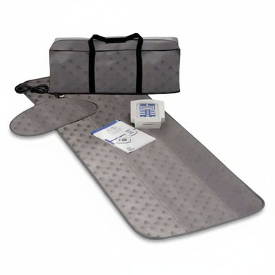 Gray travel mat with carrying bag and small box on a white background