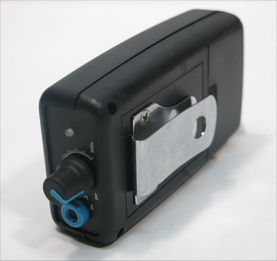 Black and silver device with a dial on a white background