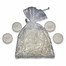 silver organza satchel tied closed and filled with small white laminar crystal rocks with four small Precious Prill disks on white background