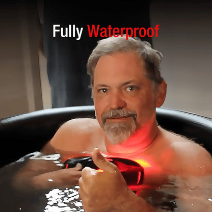 Man in a bathtub with a device labeled 'Fully Waterproof' on a dark background